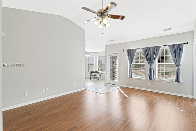 unfurnished room with lofted ceiling, hardwood / wood-style floors, and ceiling fan