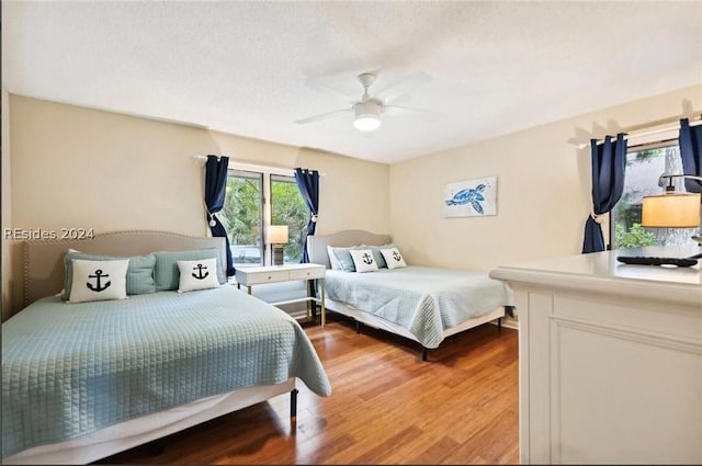 bedroom featuring ceiling fan and light hardwood / wood-style flooring