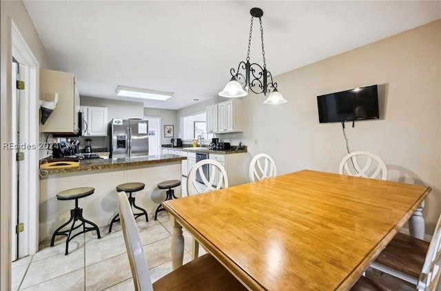 tiled dining room featuring sink