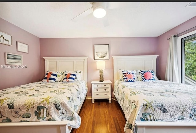 bedroom with ceiling fan and dark hardwood / wood-style flooring