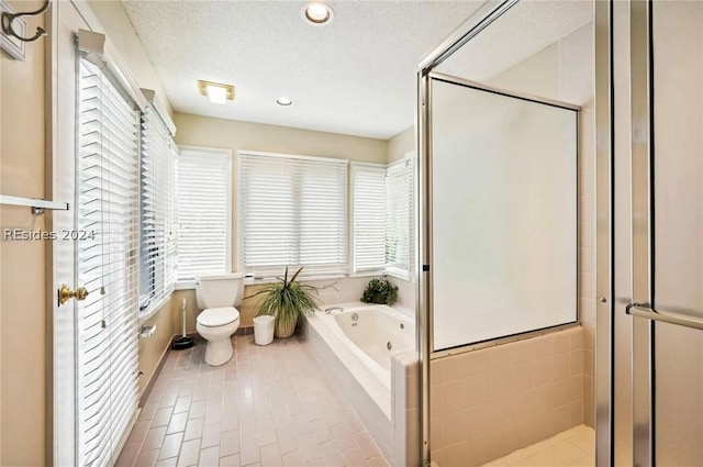 bathroom featuring toilet, separate shower and tub, tile patterned flooring, and a textured ceiling