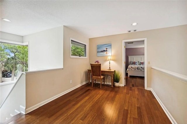 hallway with dark hardwood / wood-style flooring