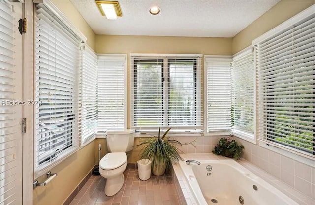 bathroom featuring tile patterned flooring, plenty of natural light, and a textured ceiling