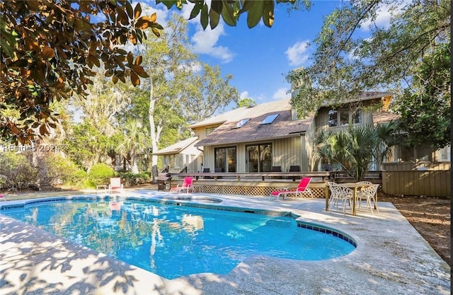 view of pool featuring a deck and a patio area