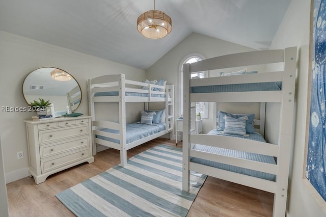 bedroom featuring vaulted ceiling and light hardwood / wood-style flooring