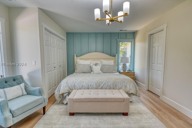 bedroom featuring an inviting chandelier, light hardwood / wood-style floors, and a closet