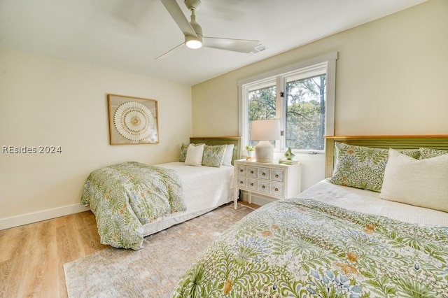 bedroom with light hardwood / wood-style flooring and ceiling fan