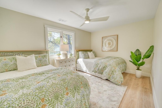 bedroom with light wood-type flooring and ceiling fan