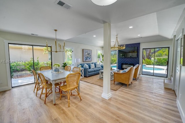 dining area with a fireplace and light hardwood / wood-style flooring