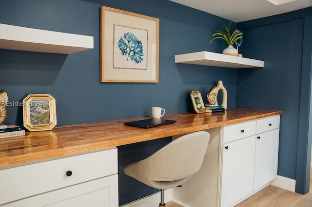 office featuring built in desk and light hardwood / wood-style flooring