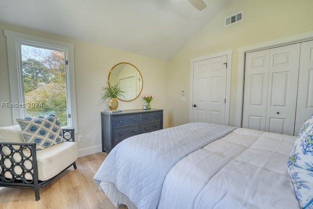 bedroom with ceiling fan, vaulted ceiling, and light wood-type flooring