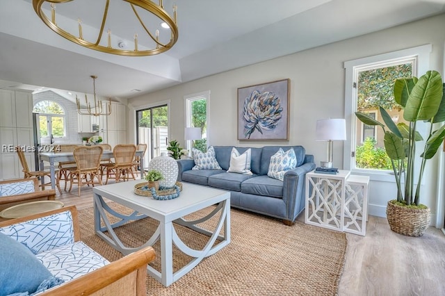 living room featuring a notable chandelier and light hardwood / wood-style flooring