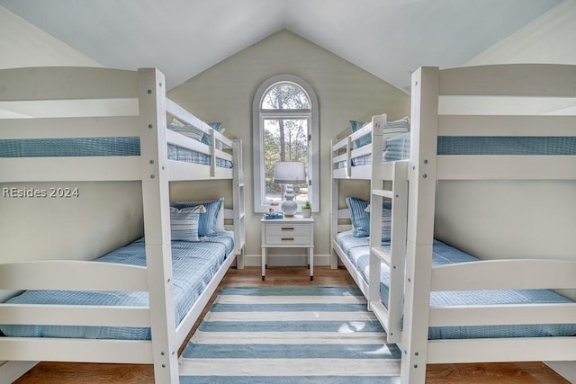 bedroom with hardwood / wood-style floors and vaulted ceiling