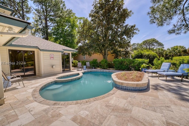 view of swimming pool with a patio and an in ground hot tub