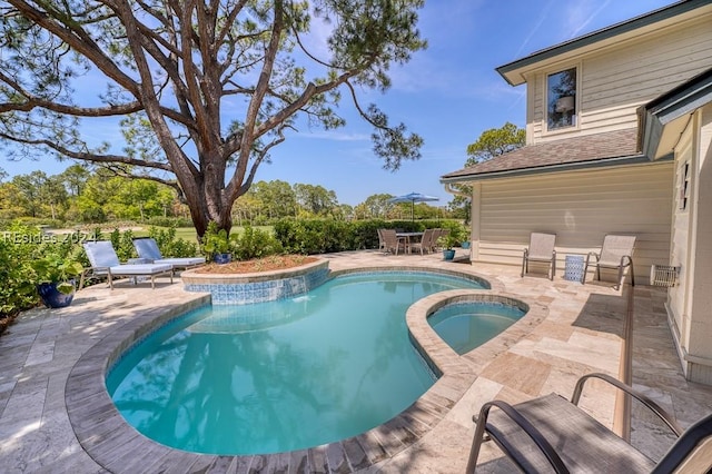 view of pool featuring a patio and an in ground hot tub