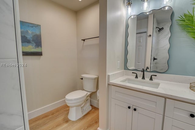 bathroom featuring vanity, hardwood / wood-style floors, and toilet