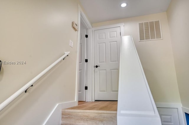 stairs featuring wood-type flooring