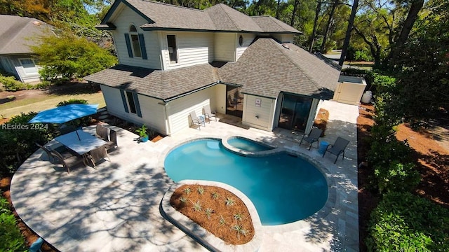 view of pool featuring an in ground hot tub and a patio area