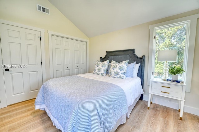 bedroom with lofted ceiling and light hardwood / wood-style floors