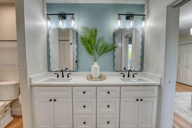 bathroom featuring vanity, hardwood / wood-style floors, and toilet