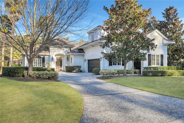 view of front of house with a garage and a front yard