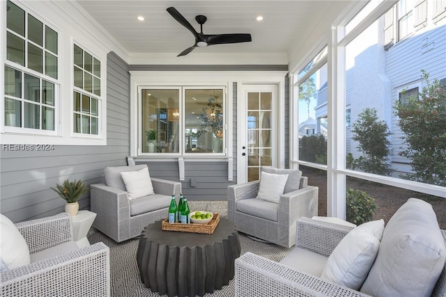 sunroom featuring ceiling fan