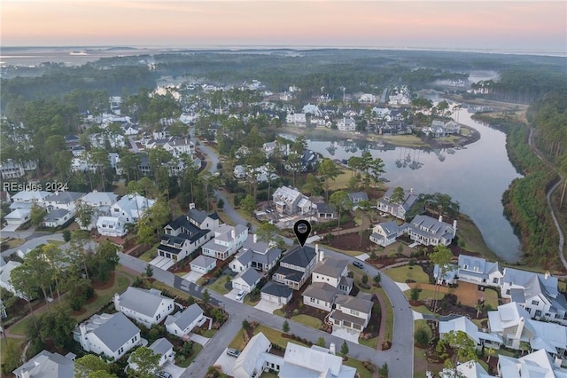 aerial view at dusk with a water view