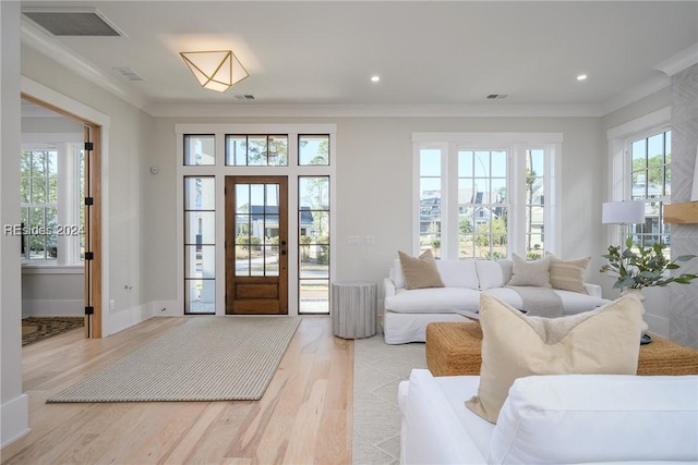 interior space featuring crown molding and light wood-type flooring