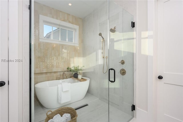 bathroom with independent shower and bath and tile walls