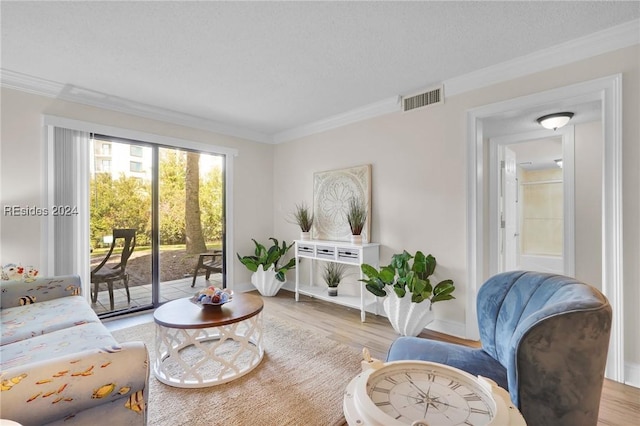 living room with crown molding and light wood-type flooring