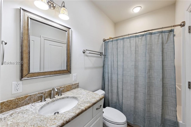 bathroom featuring vanity, toilet, and curtained shower