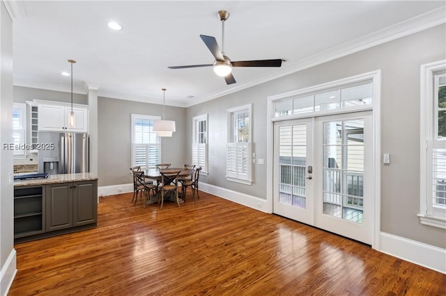 dining room with ornamental molding, dark hardwood / wood-style floors, and french doors