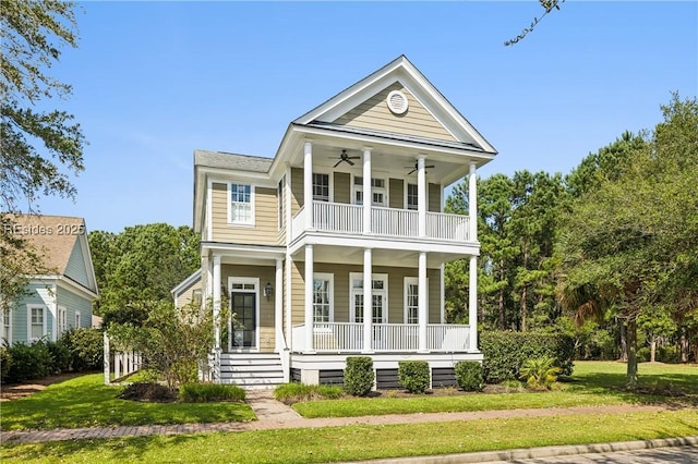 view of front facade featuring a balcony, a front lawn, ceiling fan, and a porch