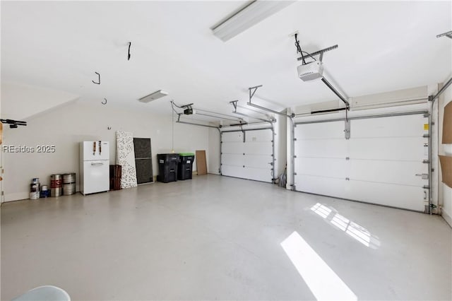 garage with white refrigerator and a garage door opener