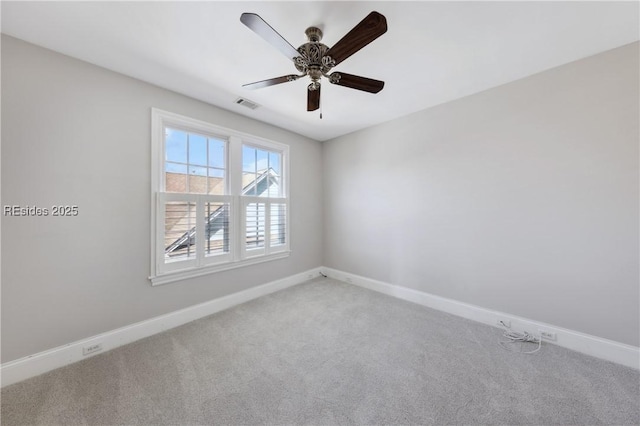 carpeted spare room featuring ceiling fan