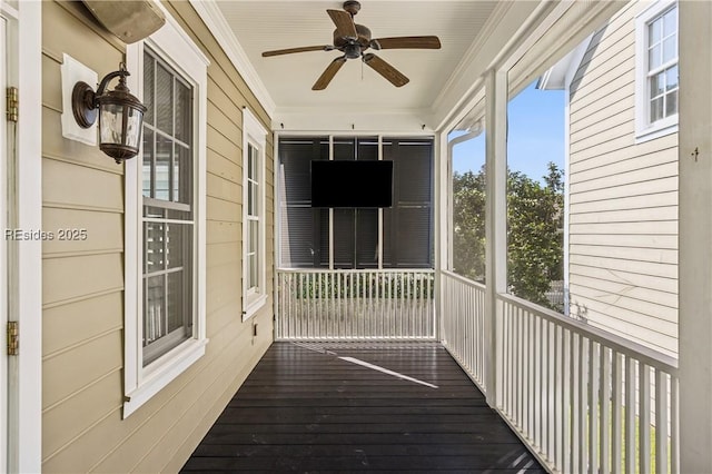 unfurnished sunroom with ceiling fan