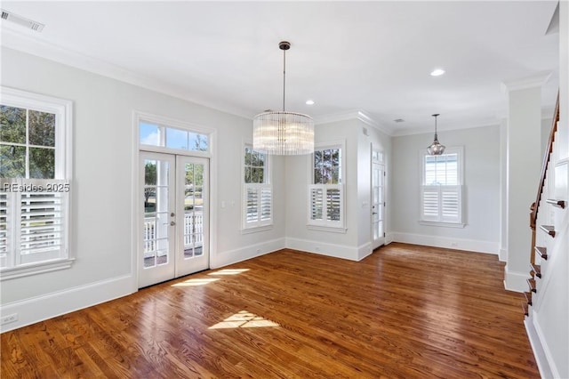 unfurnished dining area with wood-type flooring, ornamental molding, french doors, and a healthy amount of sunlight