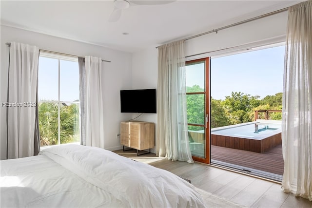 bedroom featuring light wood-type flooring, access to exterior, and ceiling fan