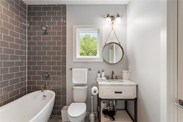 bathroom featuring a bathing tub, vanity, and toilet