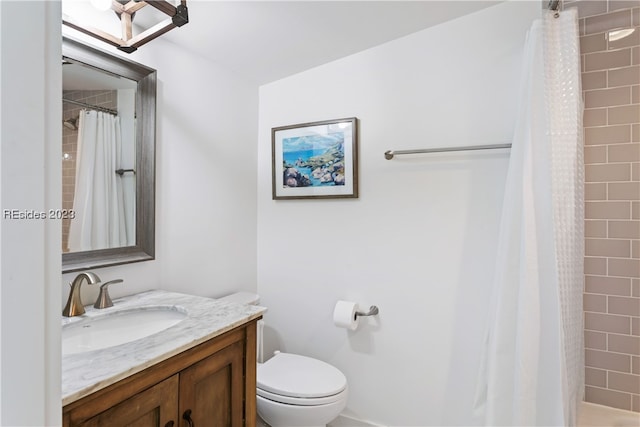 bathroom with walk in shower, vanity, and toilet