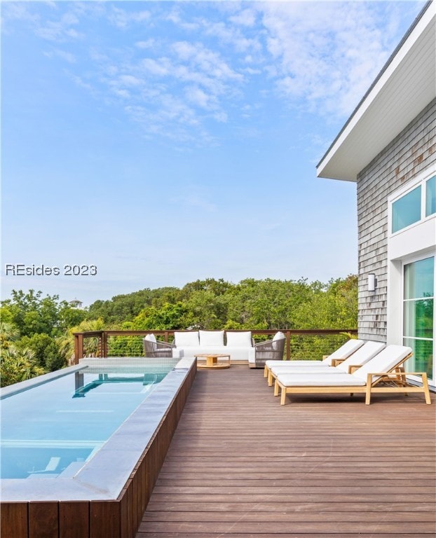 wooden terrace with a swimming pool