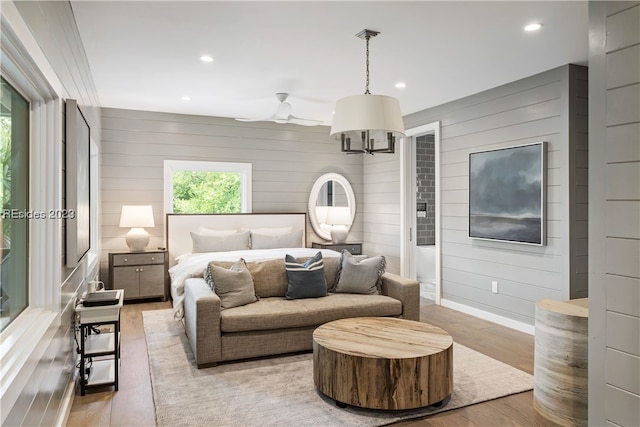 bedroom with wooden walls and light wood-type flooring