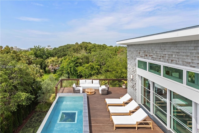 exterior space featuring a wooden deck and outdoor lounge area