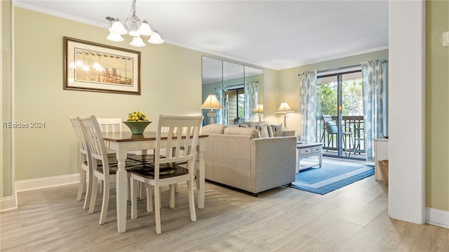 dining room featuring a notable chandelier, ornamental molding, and light wood-type flooring