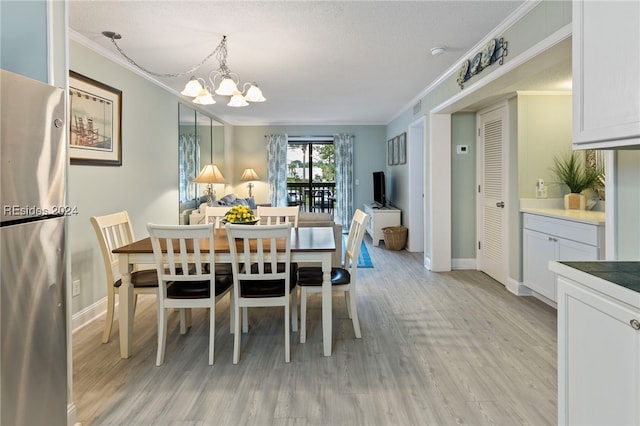 dining room featuring ornamental molding, light hardwood / wood-style floors, and a notable chandelier