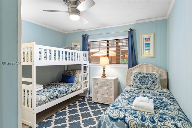 bedroom featuring crown molding, a textured ceiling, dark hardwood / wood-style floors, and ceiling fan