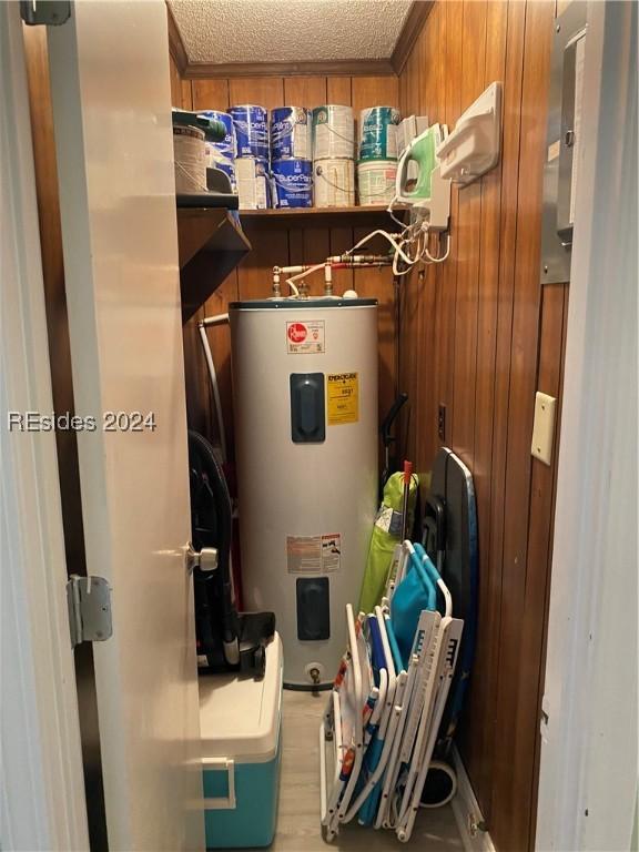 utility room featuring electric water heater