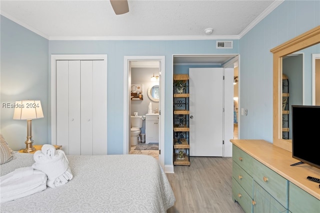 bedroom with light hardwood / wood-style flooring, ceiling fan, ensuite bathroom, ornamental molding, and a closet