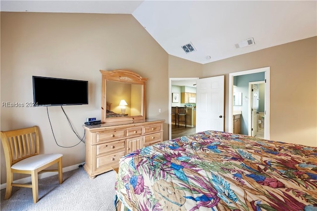 bedroom with lofted ceiling, connected bathroom, and carpet floors