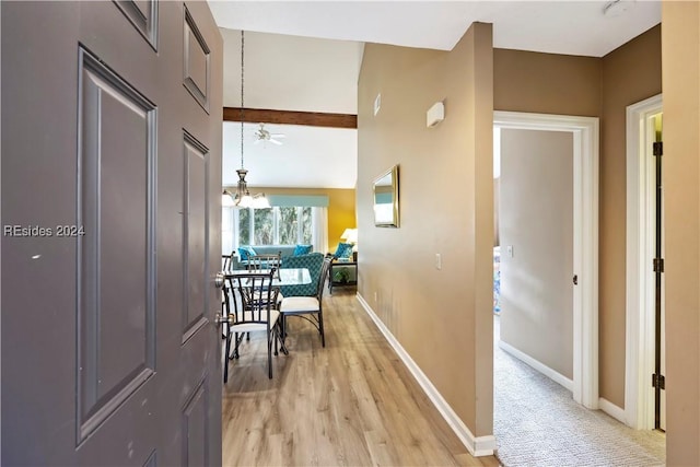 corridor featuring an inviting chandelier and light wood-type flooring